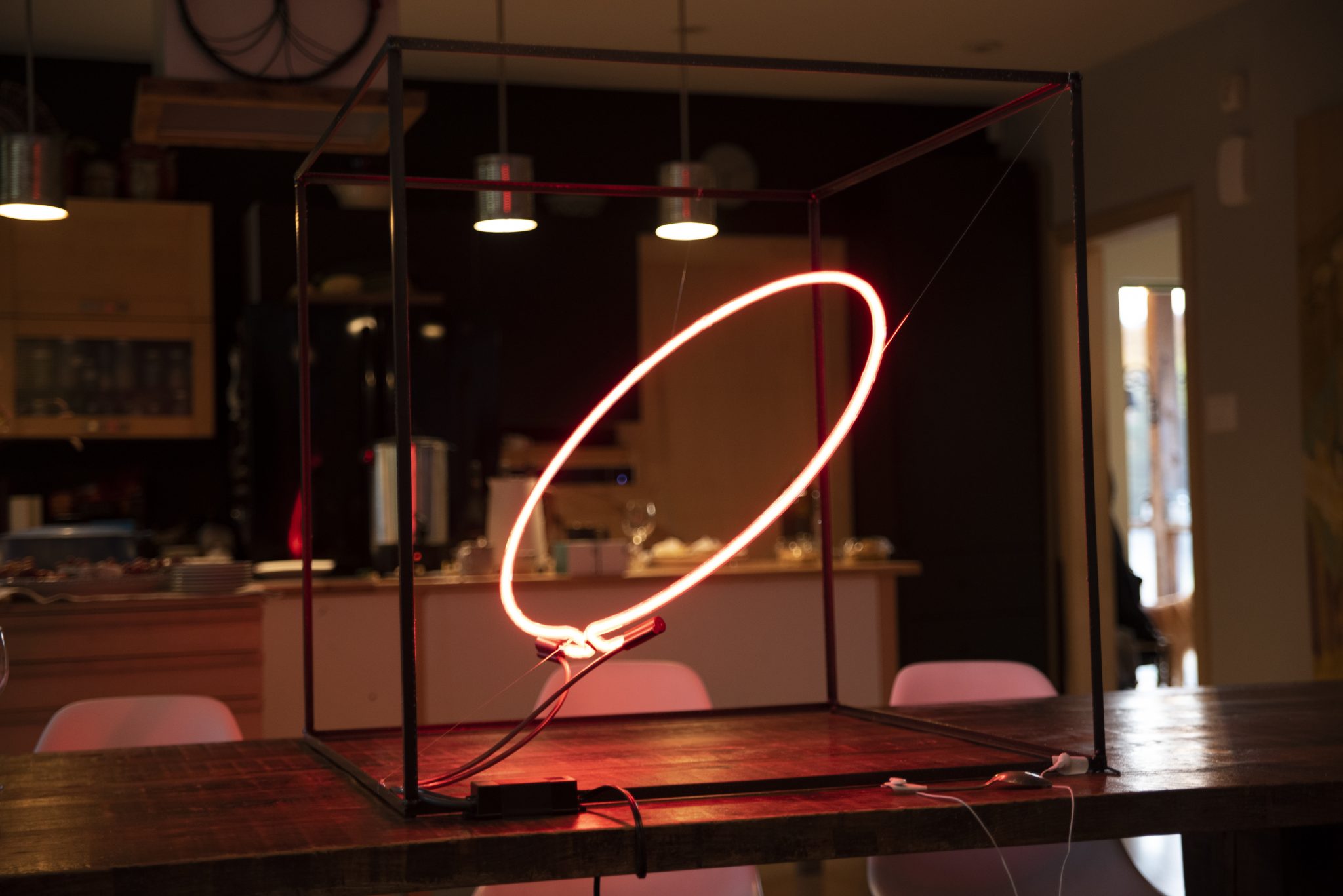 a suspended red neon circle inside the kitchen of the farm hosting the Intelligent Terrain residency