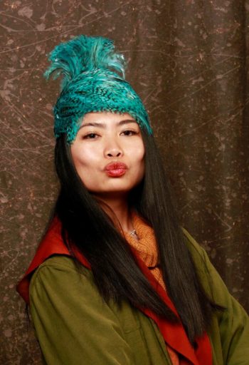 image of Bianca Weeko Martin looking cheeky in a teal hat